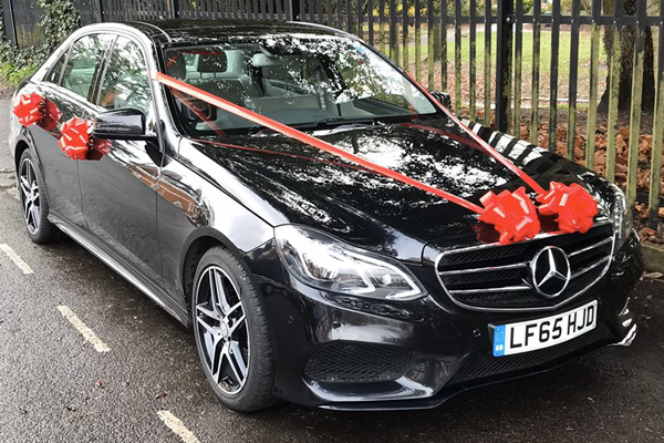 Wedding car black, red ribbons